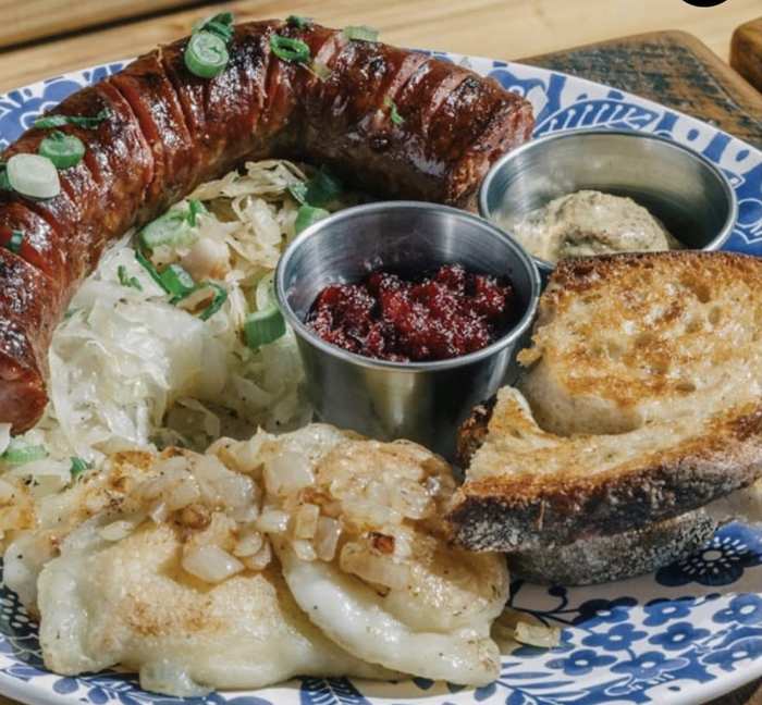 Kielbasa platter with pierogi, sauerkraut, cwikla and mustard